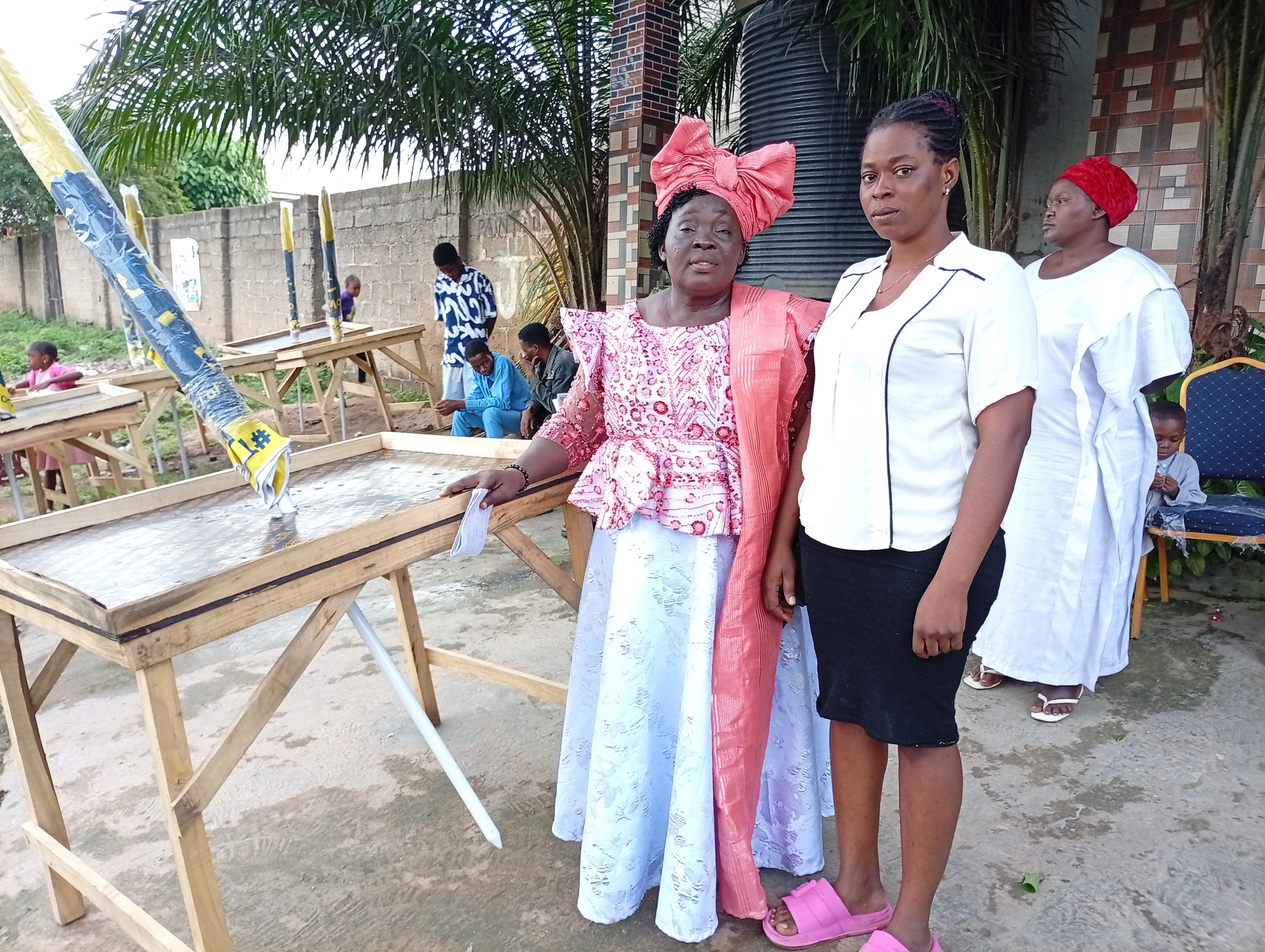 Trainees with tools and farm produce